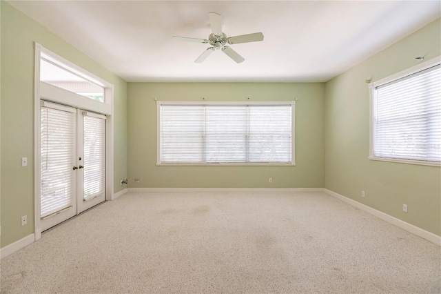 unfurnished room with light carpet, french doors, and ceiling fan