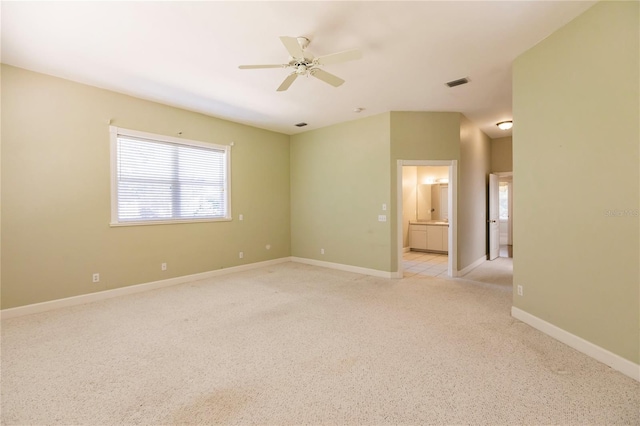 unfurnished room with light colored carpet and ceiling fan