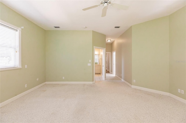 carpeted spare room featuring ceiling fan