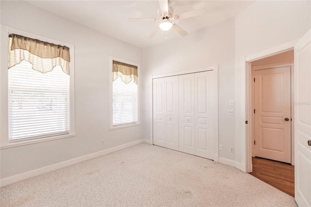 unfurnished bedroom with light carpet, a closet, and ceiling fan