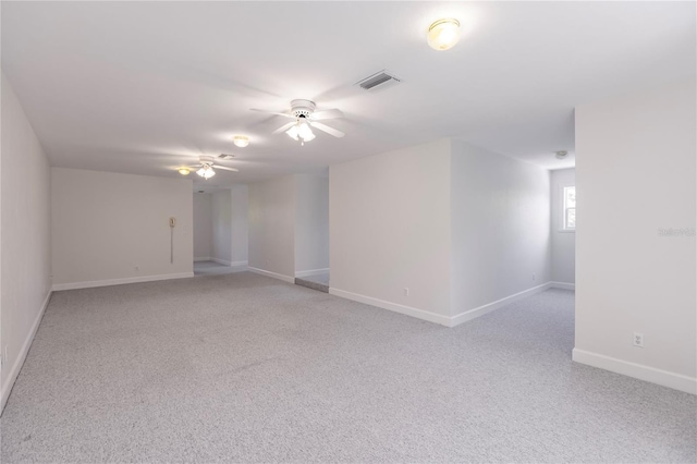 spare room with light colored carpet and ceiling fan