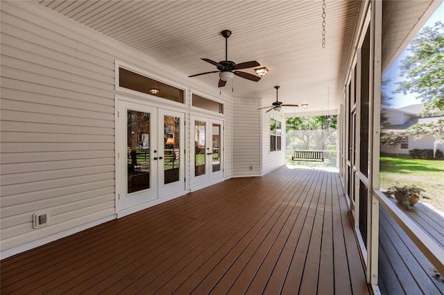 wooden deck with ceiling fan and french doors