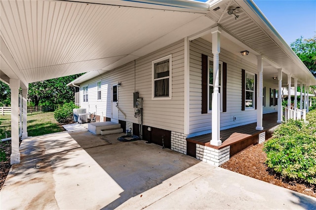 view of property exterior featuring a porch and central AC unit