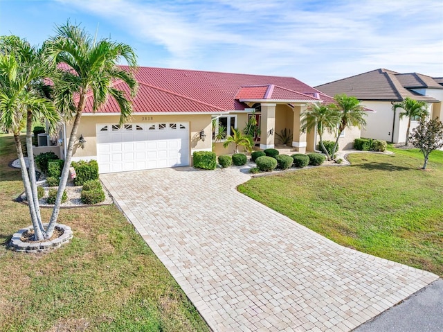 view of front of house featuring a front yard and a garage