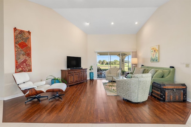 living room featuring hardwood / wood-style floors and high vaulted ceiling