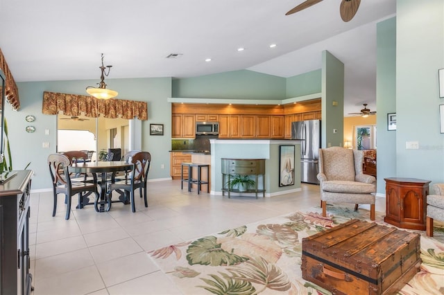 living room featuring lofted ceiling, light tile patterned floors, and ceiling fan