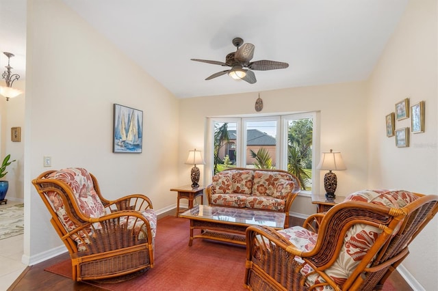 living room with lofted ceiling, hardwood / wood-style floors, and ceiling fan