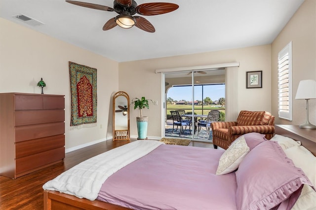 bedroom with access to exterior, dark wood-type flooring, and ceiling fan