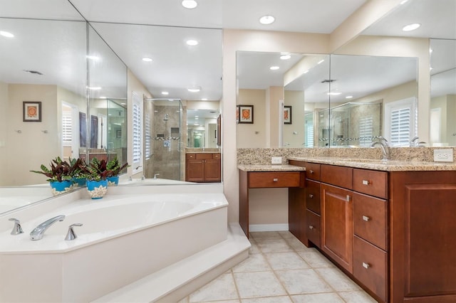 bathroom featuring independent shower and bath, vanity, a healthy amount of sunlight, and tile patterned floors