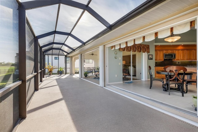 sunroom / solarium featuring lofted ceiling and ceiling fan