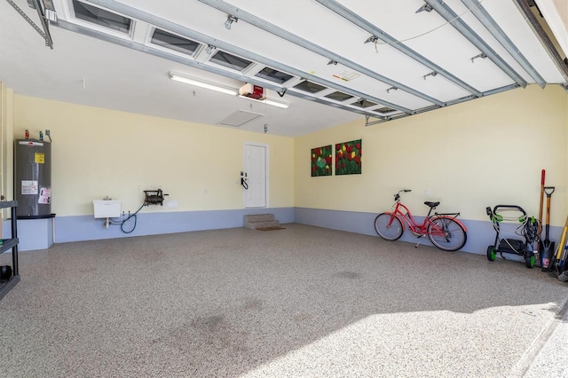 garage with a garage door opener and electric water heater