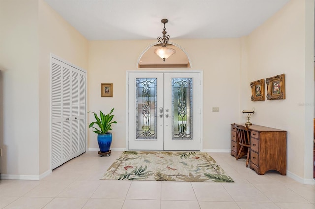 entrance foyer featuring french doors and light tile patterned flooring