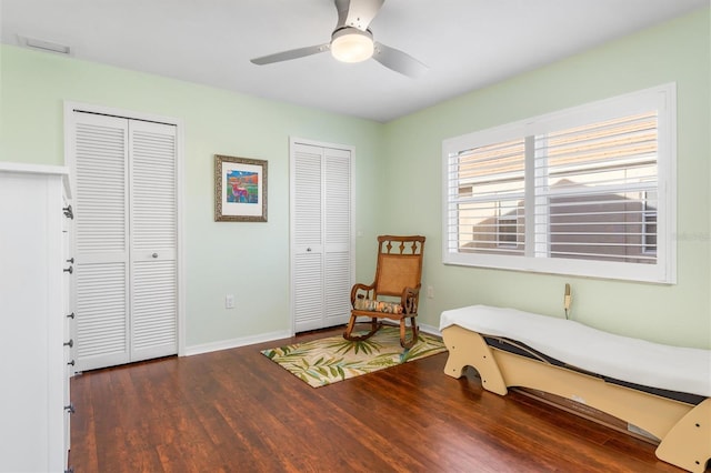 living area with dark hardwood / wood-style floors and ceiling fan