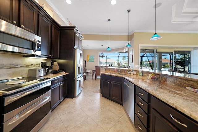 kitchen with appliances with stainless steel finishes, dark brown cabinetry, stone countertops, and hanging light fixtures