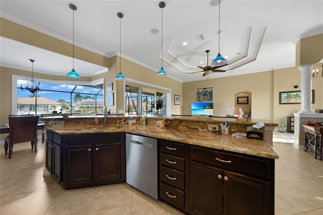 kitchen featuring ceiling fan with notable chandelier, sink, stainless steel dishwasher, a tray ceiling, and decorative columns