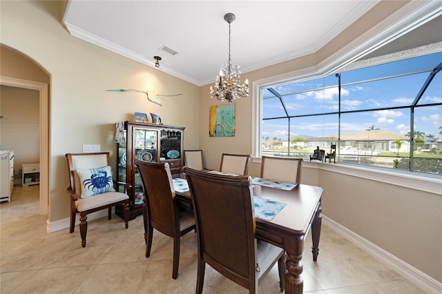 dining area featuring plenty of natural light, light tile patterned floors, ornamental molding, and an inviting chandelier