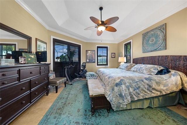 bedroom featuring a raised ceiling, ceiling fan, and crown molding