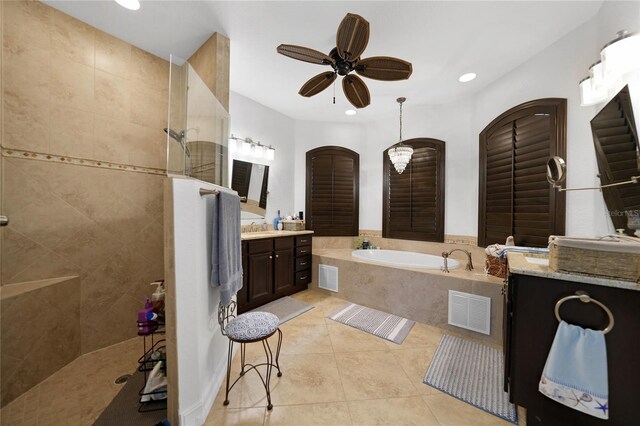 bathroom featuring tile patterned floors, vanity, ceiling fan, and shower with separate bathtub