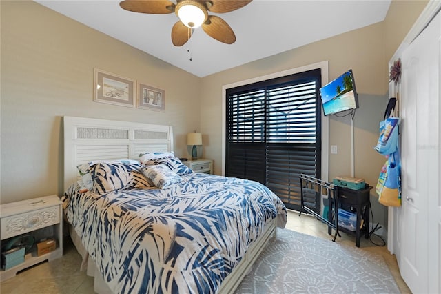 bedroom with ceiling fan and light tile patterned flooring