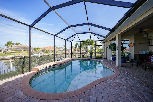 view of swimming pool featuring a patio, a water view, and a lanai