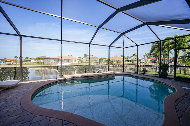 view of swimming pool featuring a water view and glass enclosure