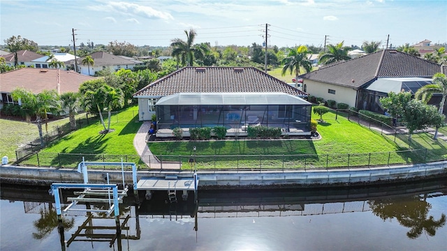 back of property featuring a lanai and a lawn