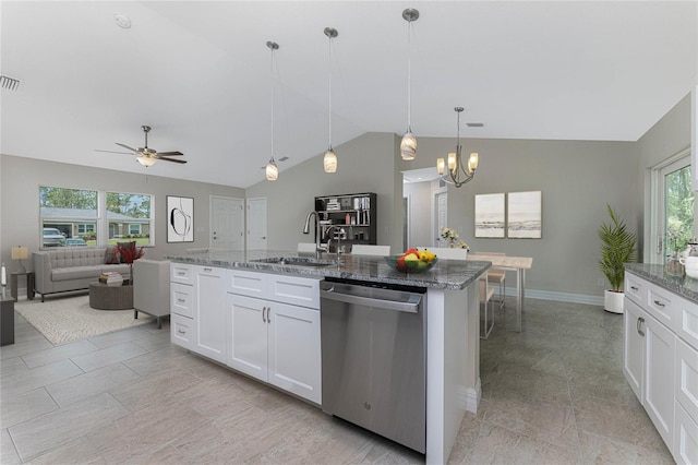 kitchen featuring white cabinetry, hanging light fixtures, stainless steel dishwasher, a center island with sink, and ceiling fan with notable chandelier