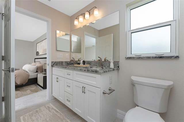 bathroom with tile patterned flooring, vanity, and toilet