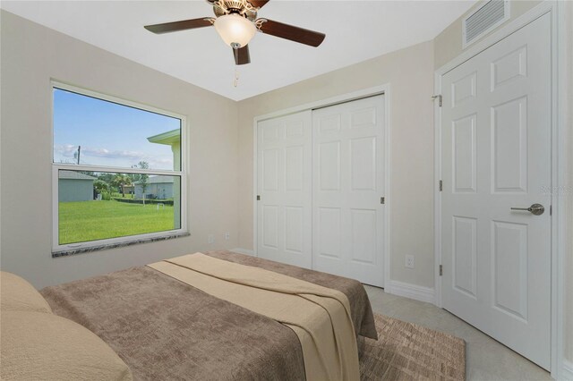 bedroom featuring ceiling fan, a closet, and light carpet