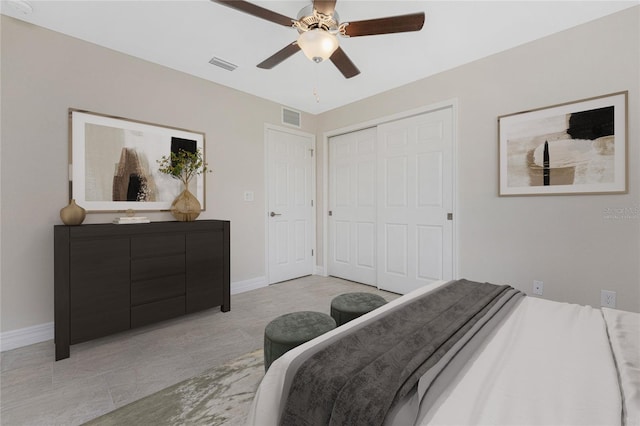 bedroom featuring ceiling fan, light tile patterned flooring, and a closet