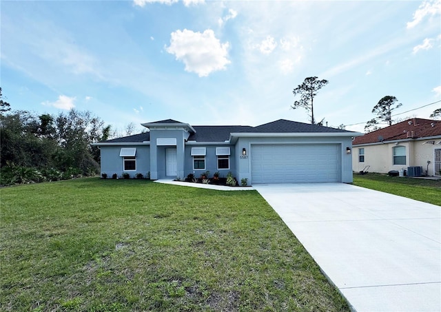 view of front of property featuring a garage, cooling unit, and a front yard