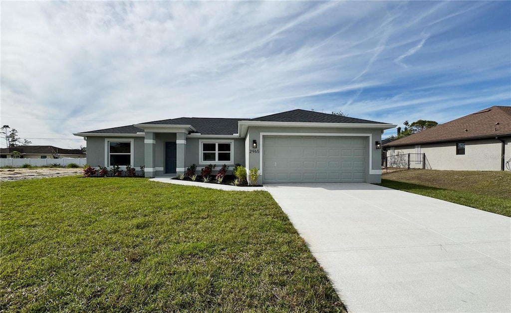 view of front facade featuring a front lawn and a garage