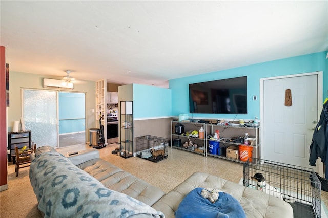 living room featuring ceiling fan and an AC wall unit