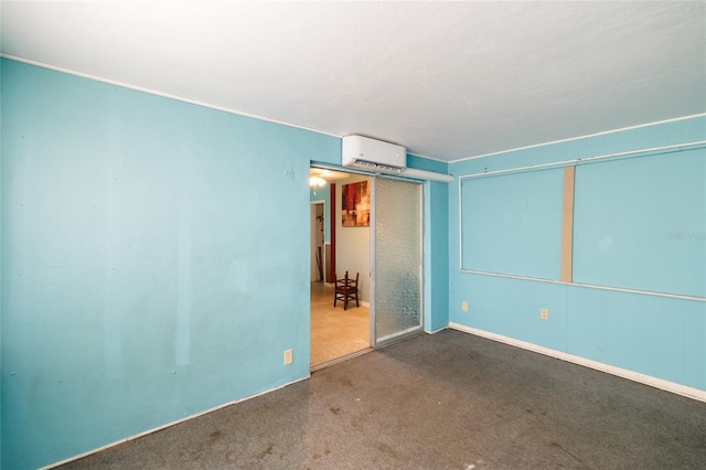 carpeted spare room featuring a wall mounted AC