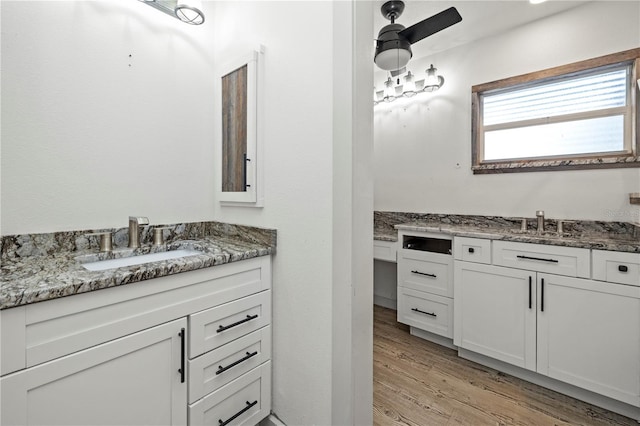 bathroom featuring hardwood / wood-style floors, vanity, and ceiling fan