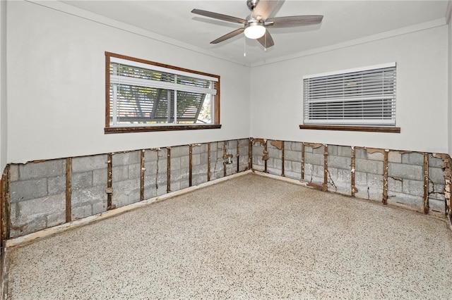 unfurnished room featuring ceiling fan and ornamental molding