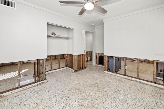 unfurnished room with ceiling fan and crown molding