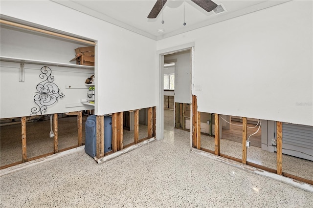 interior space with ceiling fan and crown molding