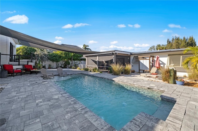 view of pool featuring a patio and a sunroom