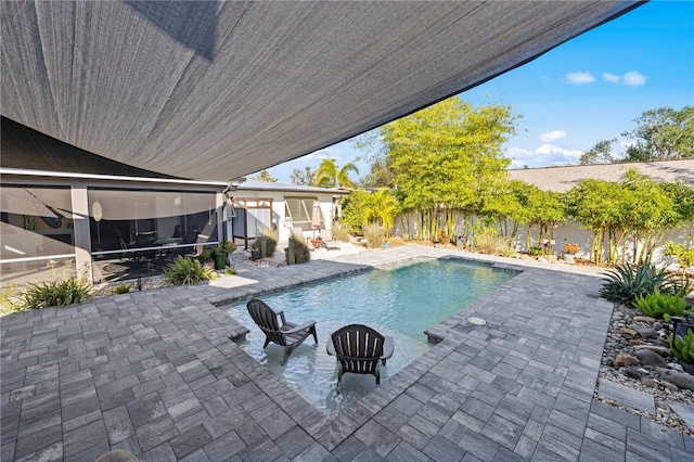 view of pool with a patio area and a sunroom