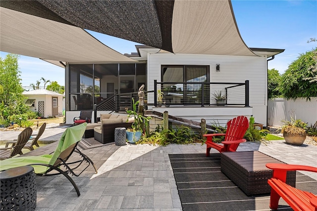 view of patio / terrace featuring a sunroom and an outdoor hangout area