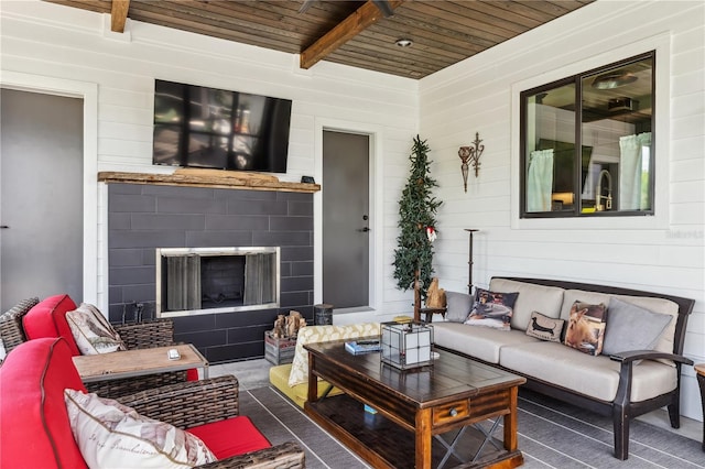 living room featuring beamed ceiling, wooden walls, and wood ceiling