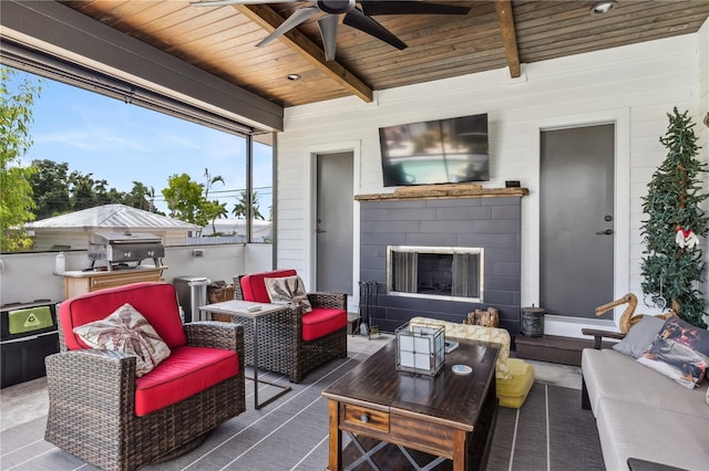 view of patio / terrace featuring an outdoor living space with a fireplace and ceiling fan