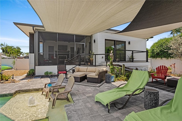 view of patio / terrace with outdoor lounge area and a sunroom