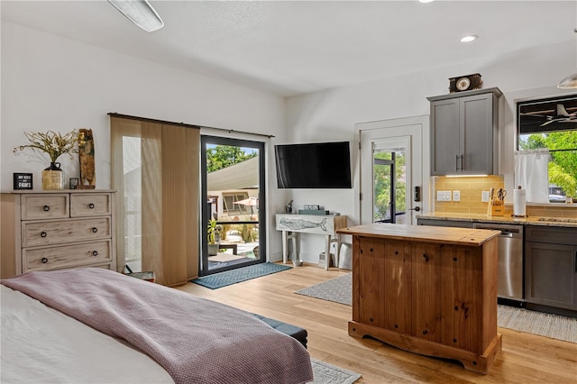 bedroom featuring light hardwood / wood-style floors, access to exterior, and multiple windows