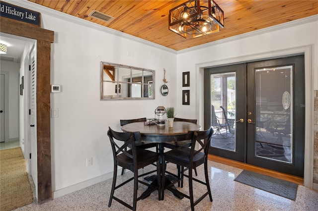 dining area with french doors, wood ceiling, a notable chandelier, and ornamental molding