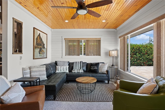 living room with wooden walls, ceiling fan, and wood ceiling