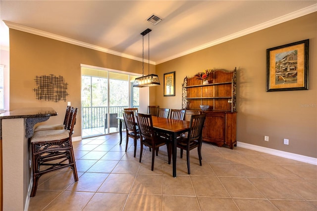 dining space with light tile patterned floors and ornamental molding