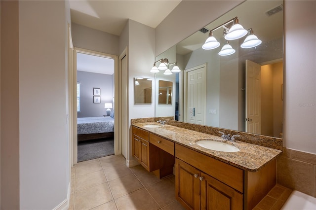 bathroom with tile patterned floors and vanity