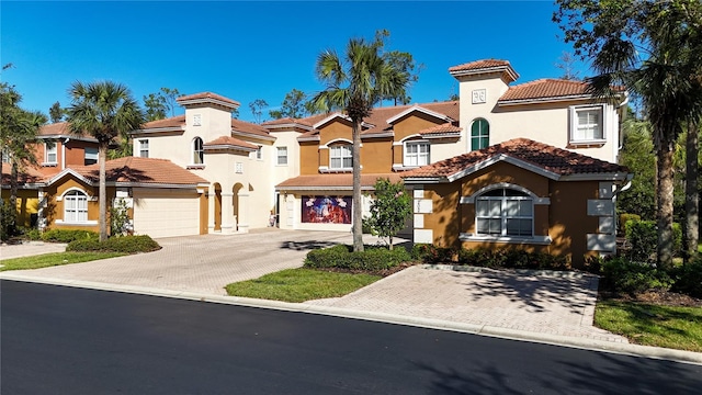 mediterranean / spanish-style house with a garage